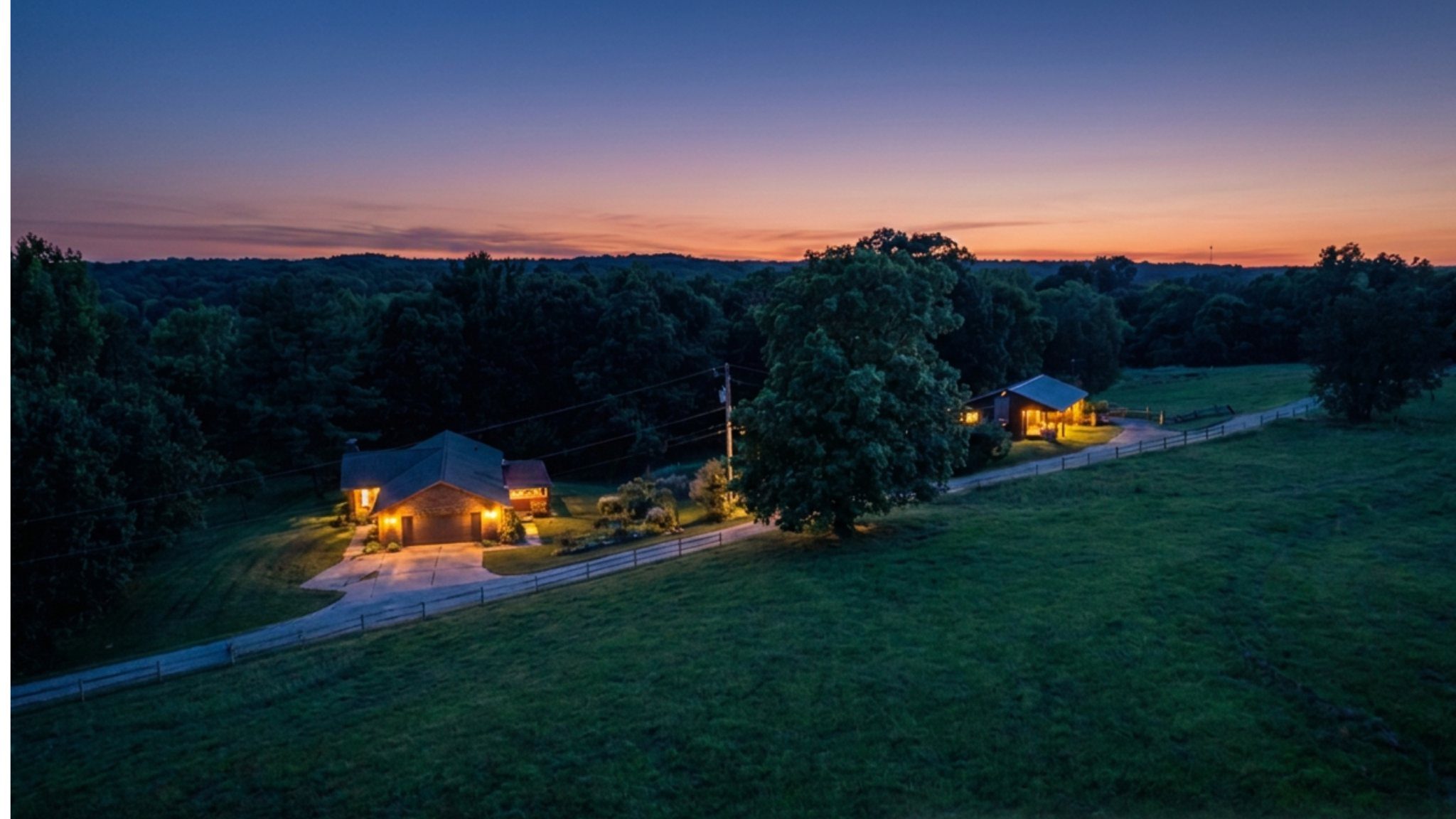 Twilight view of home sites and pasture along the roadway