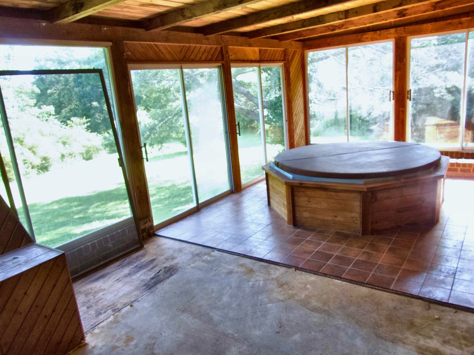 2555 residence — glass sunroom with soaking tub and wooded views