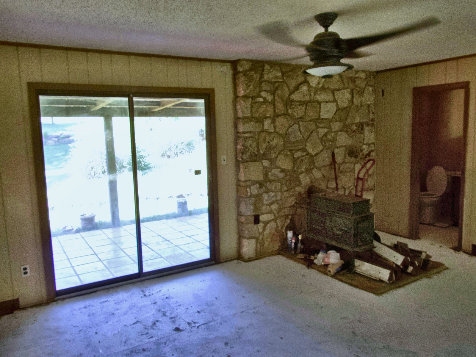 2555 residence — den with stone accent wall and covered-patio access
