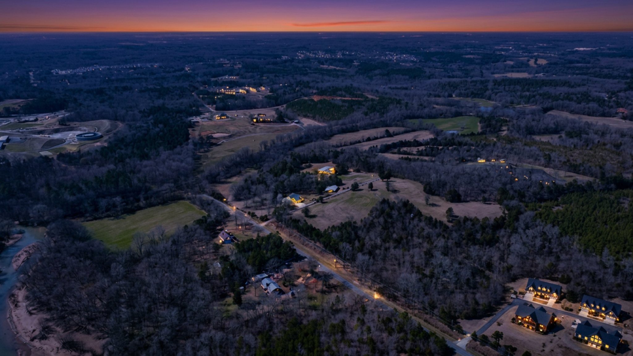 Expansive twilight aerial with estates and rural landscape