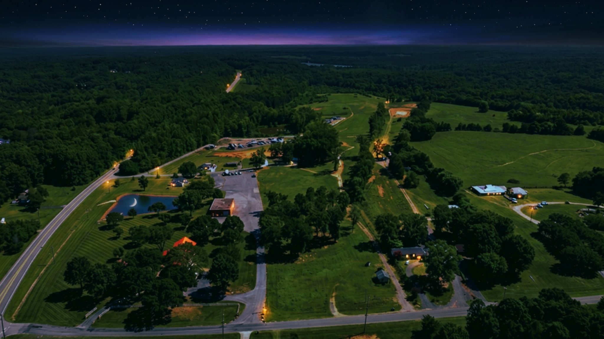 Night aerial over Biggers Road with illuminated roads and buildings