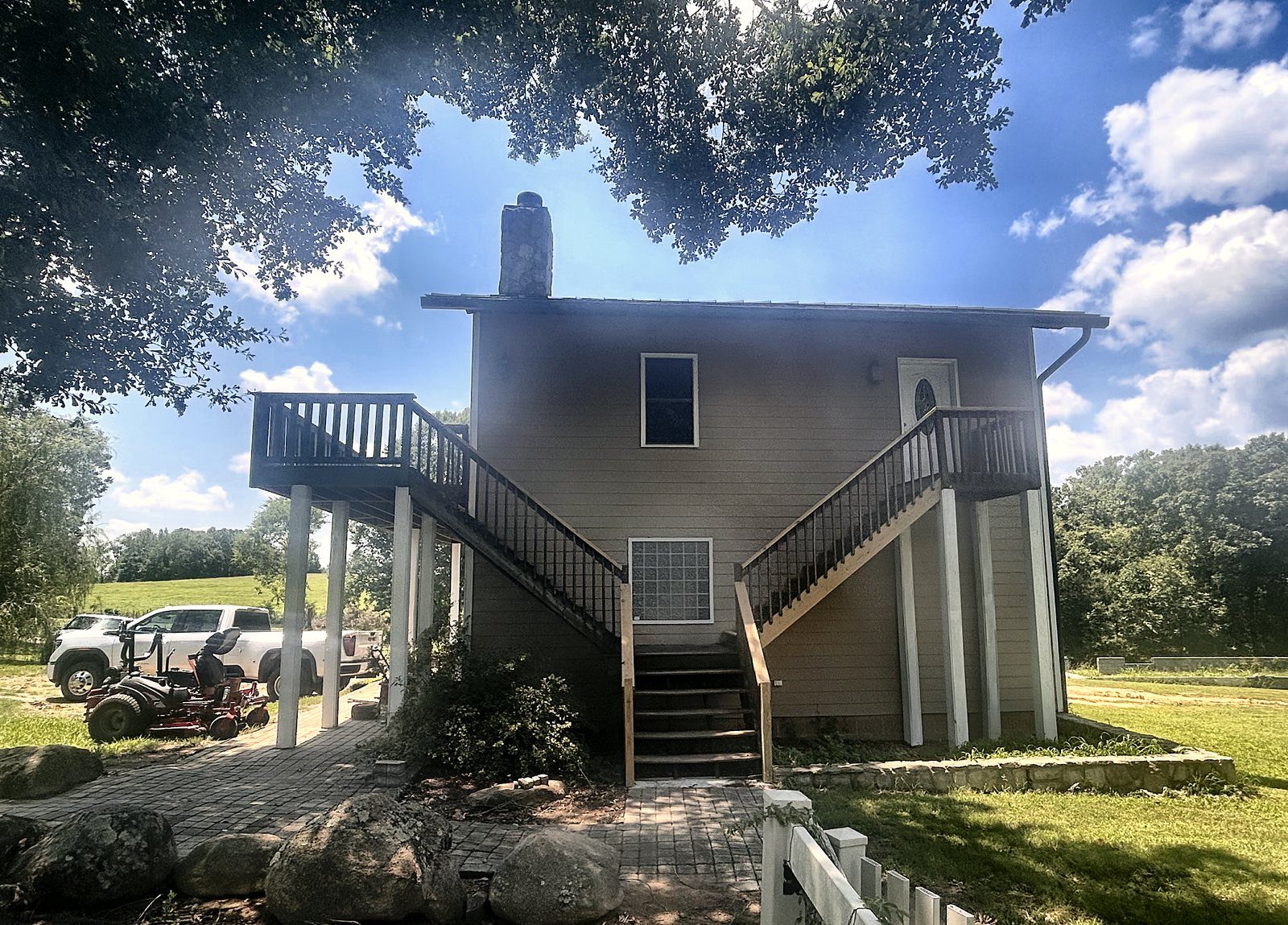 3400 Biggers Road — dwelling rear exterior with dual staircases and upper decks