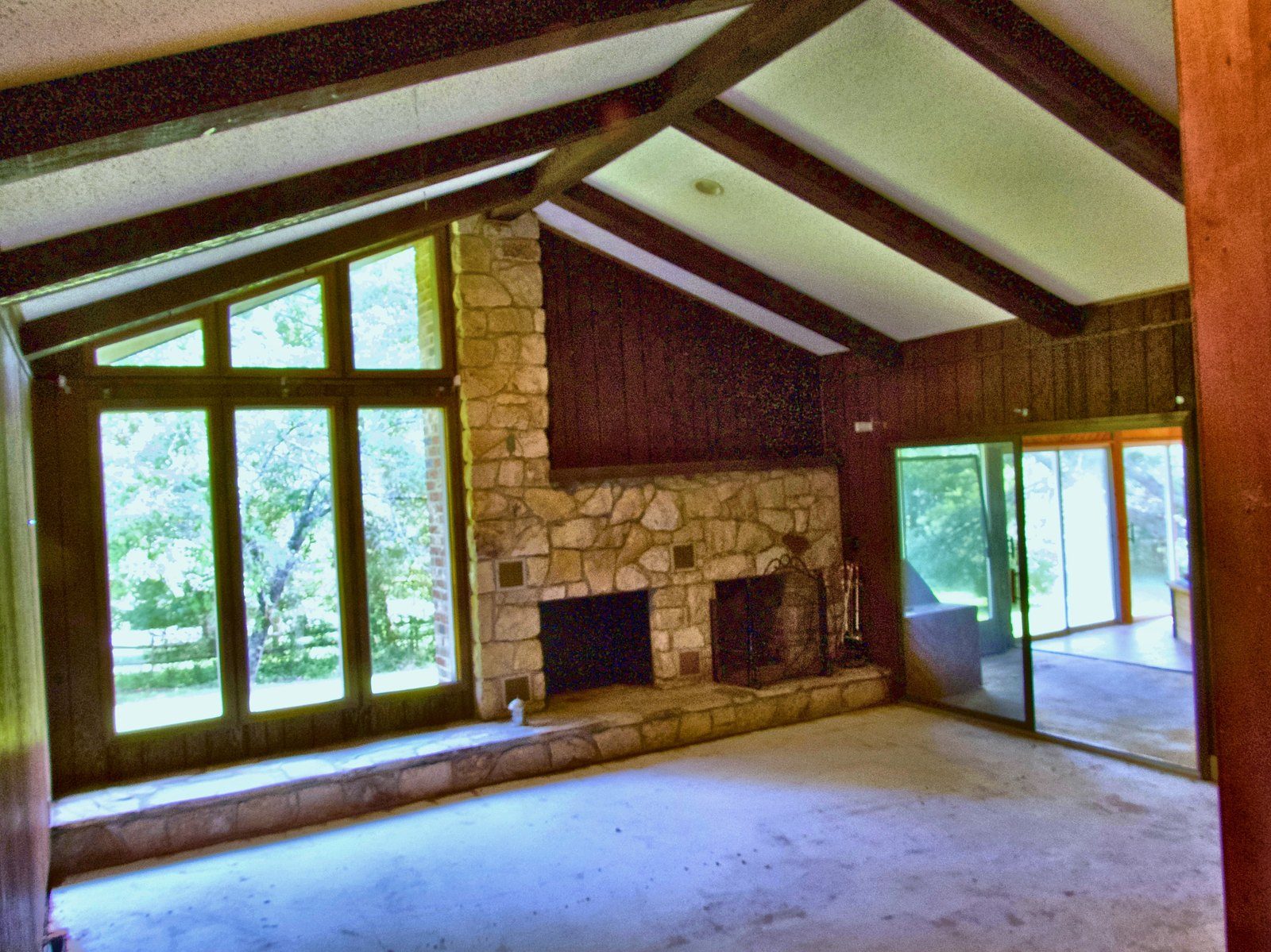 2555 residence — great room with floor-to-ceiling stone fireplace and vaulted beamed ceiling