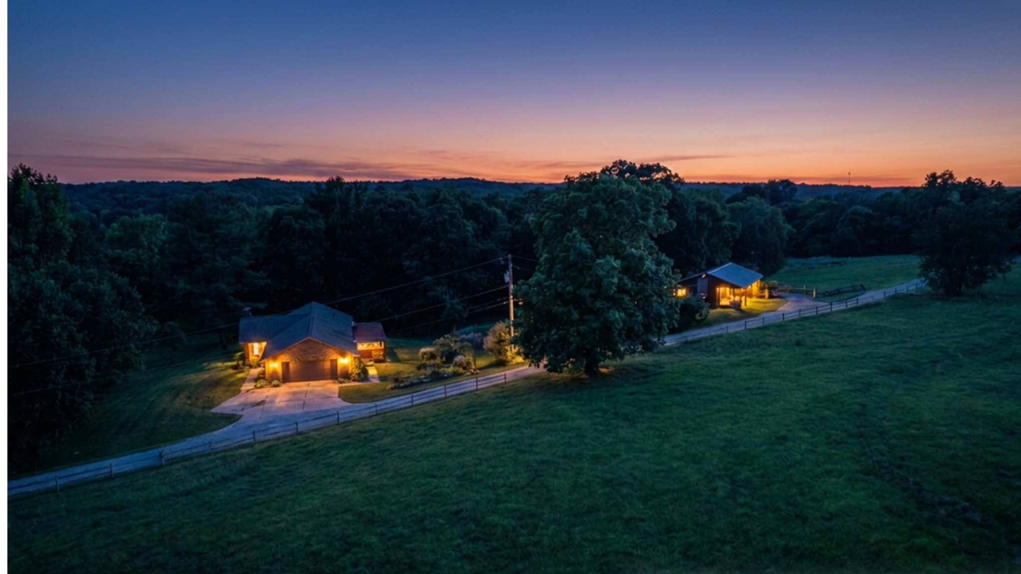 2555 Biggers Road — aerial over the homestead and barn at golden hour